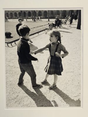 It's OK to say no - pair of kids playing in a Parisian square, expressive girl pushing boy away by Michael Joseph