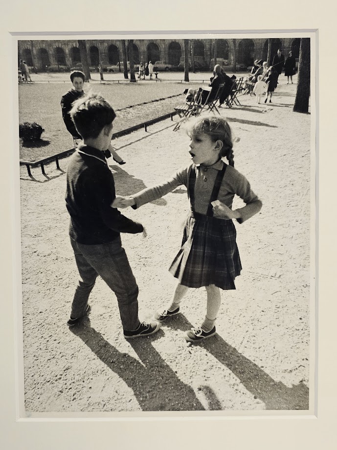 It's OK to say no - pair of kids playing in a Parisian square, expressive girl pushing boy away by Michael Joseph