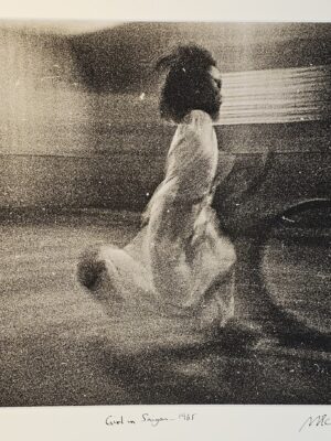 South Vietnam street girl playing with hoop just before dusk curfew bell tolls by Michael Joseph