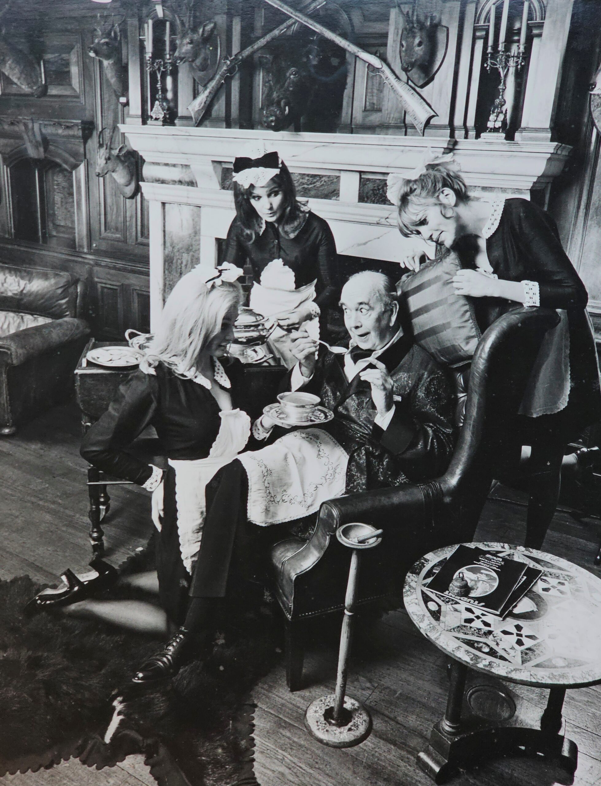 Sterotypical lord of manor with maids serving Maggi - advertisement test print by Michael Joseph