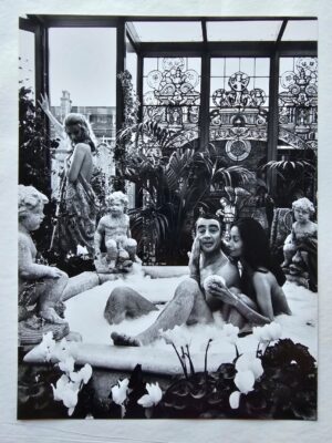 Rooftop ménage à trois Bubble bath couple with blonde nearby sexy seventies unconventional advert by Michael Joseph