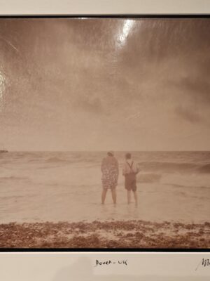 Couple paddling in sea in Dover, a life insurance advert test print by Michael Joseph