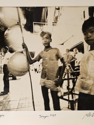 South Vietnam beggar children selling balloons for survival out in the street by Michael Joseph