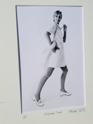 Pretty blonde model holding her glasses with her teeth, say oh really - only by Michael Joseph