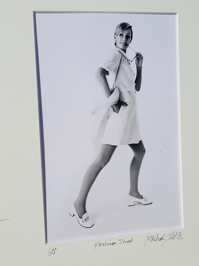 Pretty blonde model holding her glasses with her teeth, say oh really - only by Michael Joseph