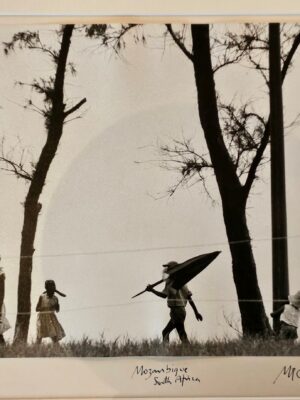 Mother with children on Mozambique beach, austere trees and desertic seascape by Michael Joseph