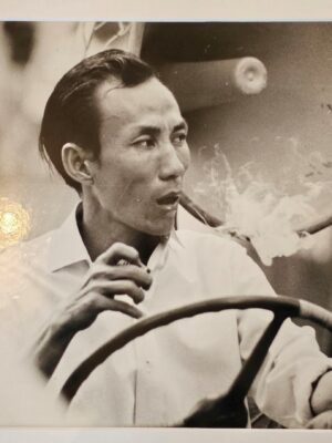 Smoker at the wheel in Qui Nhon, Vietnam, darkroom print by Michael Joseph