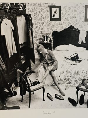 Girl pulling up tights on bed, flowery wallpaper, tennis racket and wardrobe, students of the sixties authentic vintage darkroom print