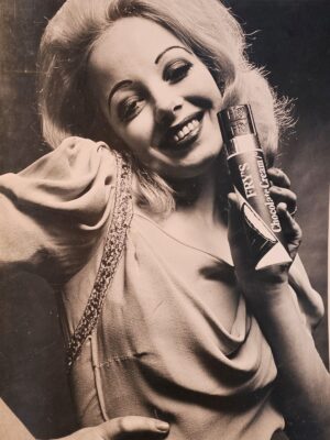 Smiley blonde holding her Fry chocolate bar suggestively, Solo Power Collection casting out-take by Michael Joseph