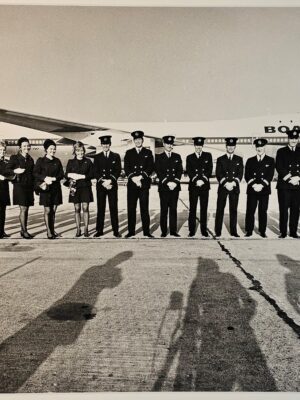 BOAC airplane with crew line-up, photographer's team's shadows in foreground, test print by Michael Joseph