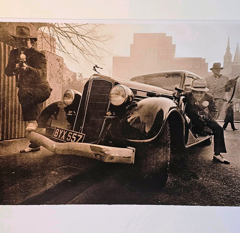 Esso getaway - men toting machine guns in the East end of London in the sixties by Michael Joseph
