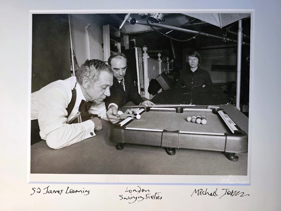 Sid James playing pool on a mini table, test-print for an advert by Michael Joseph