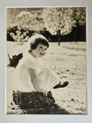 Pretty little girl in a white dress outside in her garden in Johannesburg by Michael Joseph