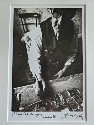 William Chesher with glasses signing, portrait from the sixties by Michael Joseph
