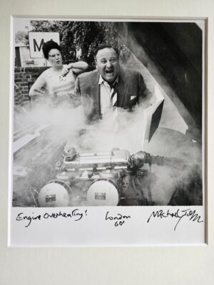 Engine over-heating! Train fan with grumpy wife behind, a sixties classic by Michael Joseph