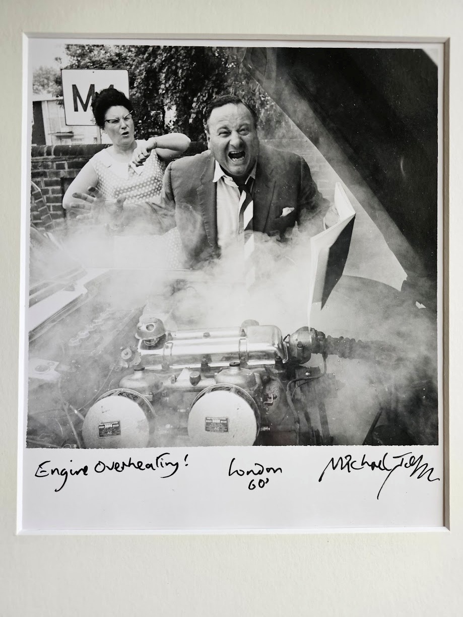 Engine over-heating! Train fan with grumpy wife behind, a sixties classic by Michael Joseph