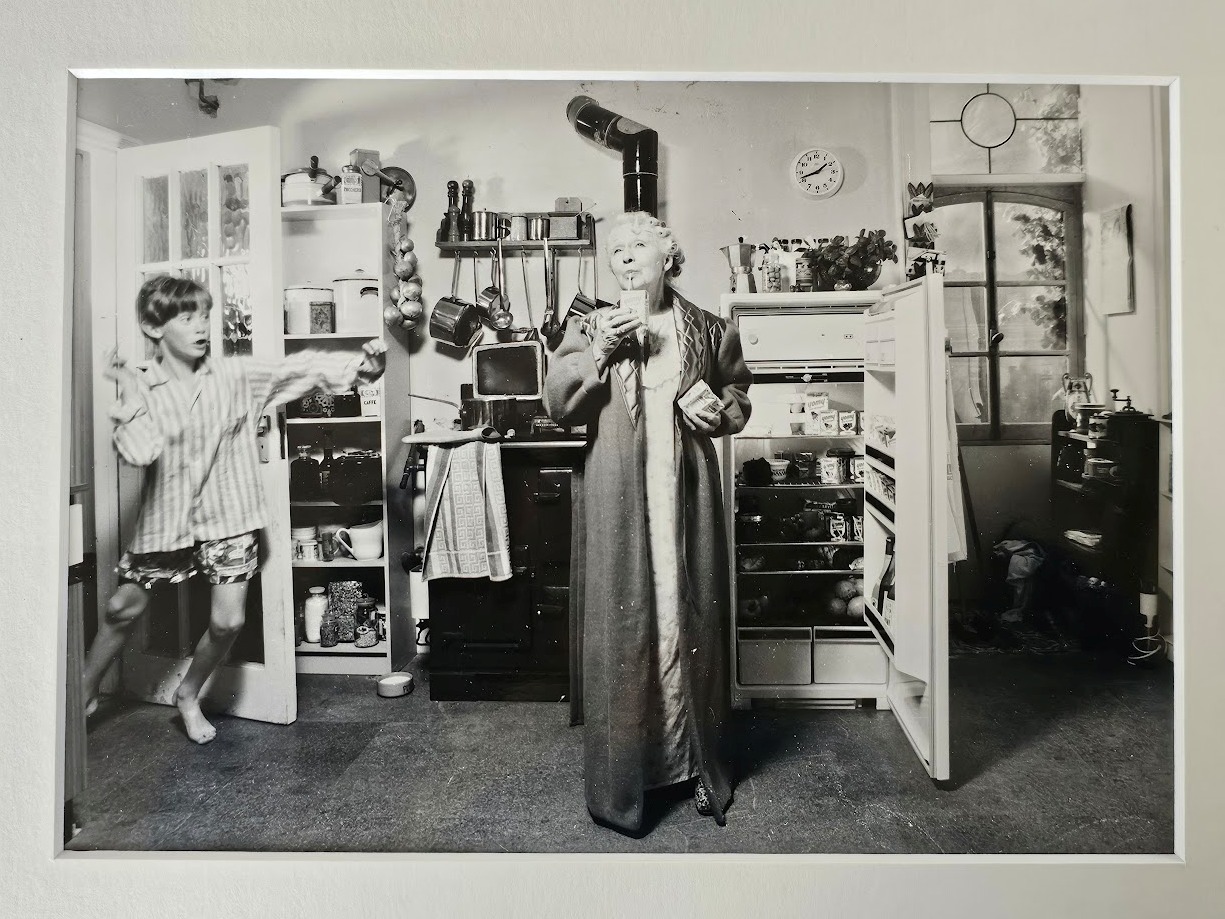 Child enters kitchen to catch Granny having a midnight snack by Michael Joseph