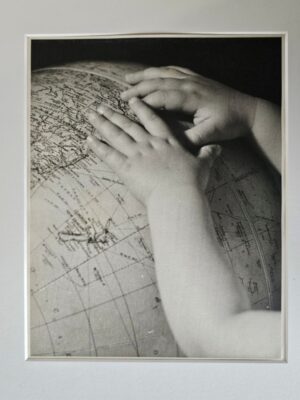 Child's hands on a globe, discovering the world is good, a timeless photograph by Michael Joseph