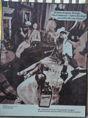 "Don't you have anything for a lady?" butler foreground, Mick Jagger background, Cointreau ad by Michael Joseph