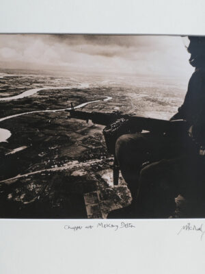 Chopper over McKong Delta, South Vietnam, soldier poised in army helicopter by Michael Joseph